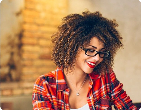 A woman with glasses and a plaid shirt.