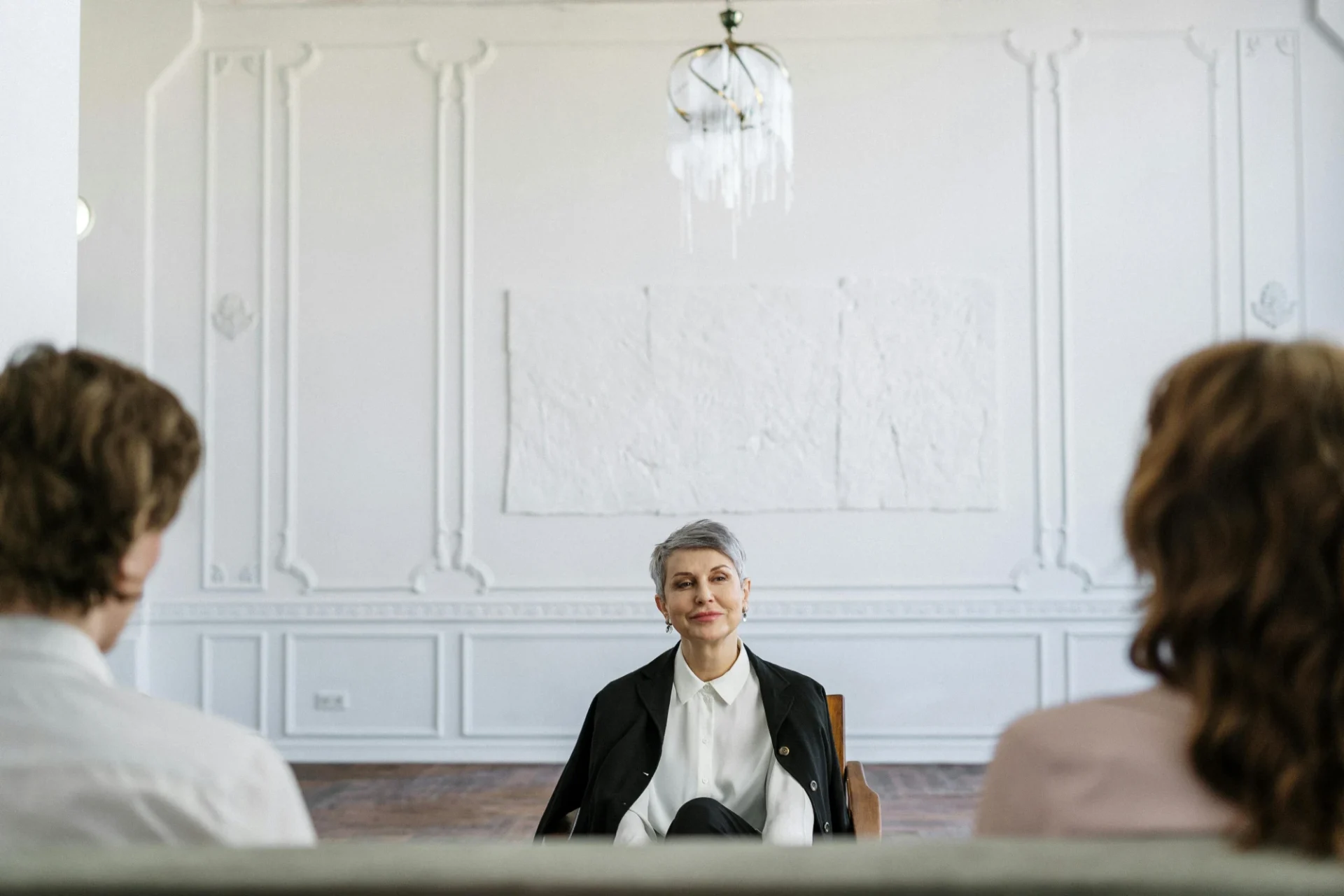 A woman sitting in front of a group of people.